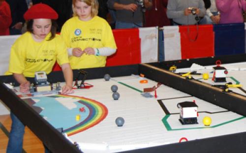 Two members of the Girl Scouts of Nassau County in Hicksville – Team 2052 "LEGO Chicks" guide their robot on the course at the January 11 Long Island LEGO League Tournament.